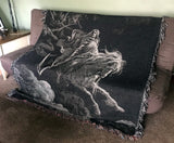 dark woven blanket with gustave dore art on it