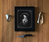 dark art framed print with bones around it